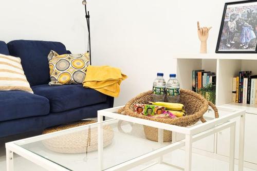 a living room with a blue couch and a table at Precioso piso en el centro de la ciudad con vistas in Santa Cruz de Tenerife