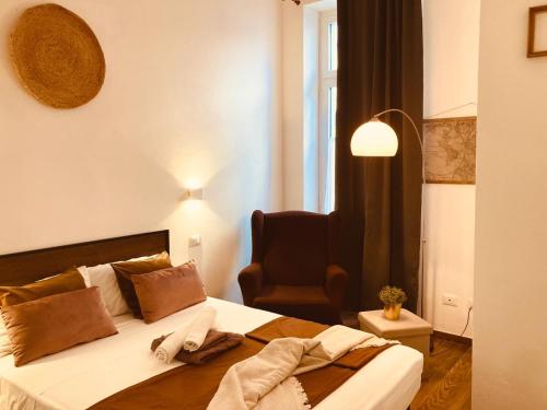 a hotel room with a bed and a chair at Domus Mylae in Milazzo