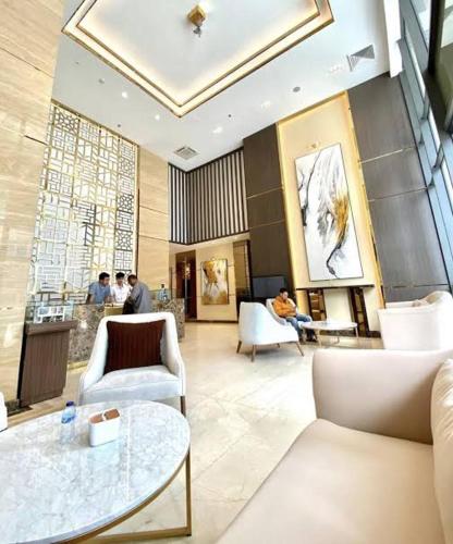 a lobby with white furniture and people in a building at 2 BR Apartment Grand Jati Junction Medan view City 12th Floor in Medan