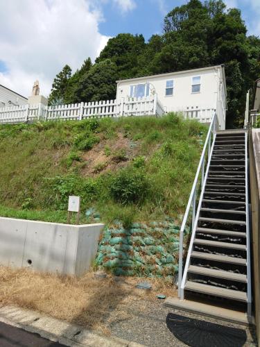 a set of stairs leading up to a building at 白キツネのおうち in Nagatsutachō