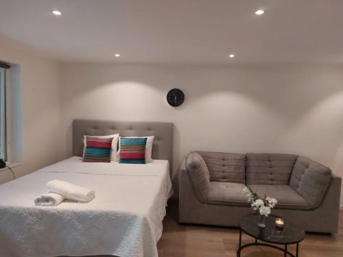 a bedroom with a bed and a chair at Nice apartment in Växjö in Växjö