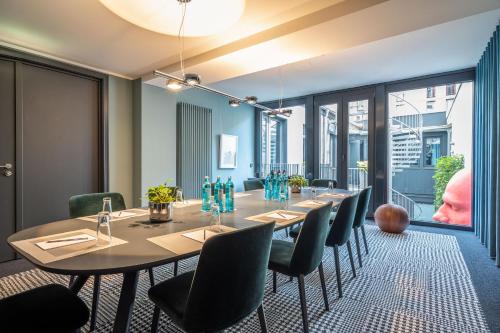 a conference room with a long table and chairs at The Midtown Hotel in Cologne