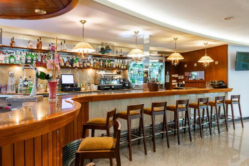 a bar with a row of stools in a restaurant at Suite Hotel S'Argamassa Palace in Santa Eularia des Riu