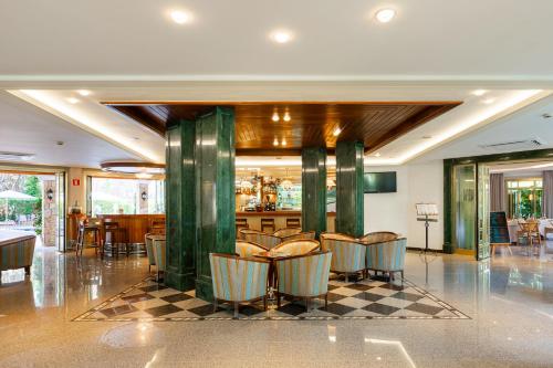 a lobby with chairs and a bar in a restaurant at Suite Hotel S'Argamassa Palace in Santa Eularia des Riu