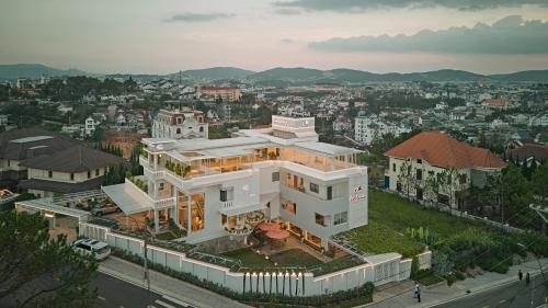 a large white house on top of a city at California Hotel in Da Lat