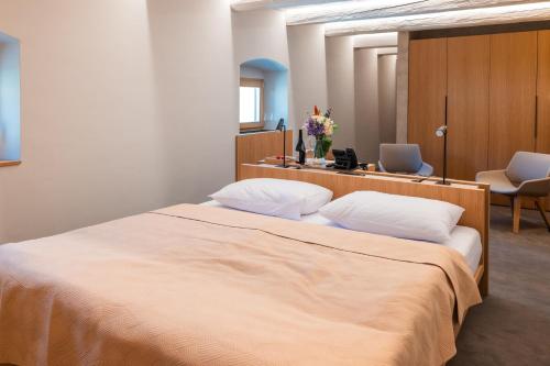 a bedroom with a large bed with two pillows at Granarium in Ilok