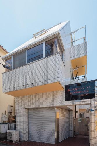 a brick building with a garage at self-check in-新大久保マンション in Tokyo