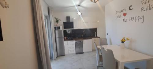 a kitchen with a table and a dining room at Josip in Nin