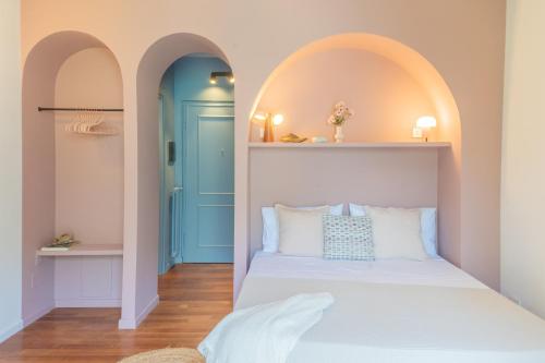 a bedroom with two arched doors and a bed in a room at OC Lake Love by Rent All Como in Laglio