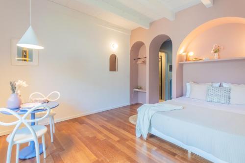 a bedroom with a bed and a table at OC Lake Love by Rent All Como in Laglio