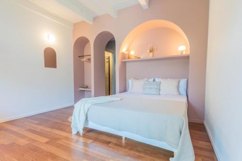 a bedroom with a bed with an arch above it at OC Lake Love by Rent All Como in Laglio