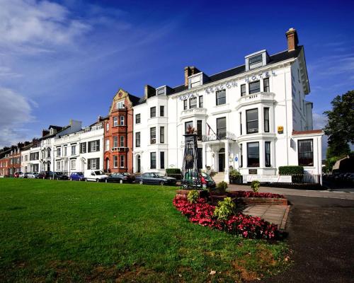 a large white building with flowers in front of it at Royal Beacon Hotel in Exmouth