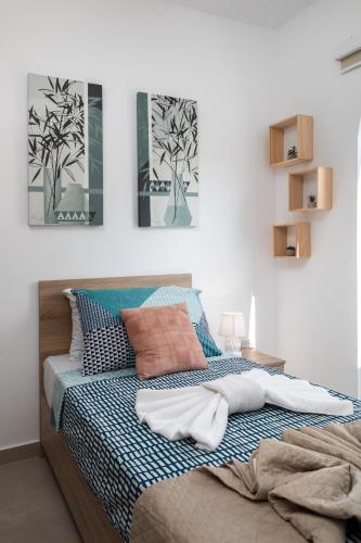 a bedroom with a bed with blue and white at Modern 2BR Stylish Apartment with 2 Balconies - Close to St Julian's & Sliema & Yacht Marina in Tal-Pietà