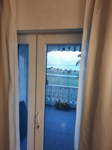 a door to a balcony with a view of a window at Josip in Nin
