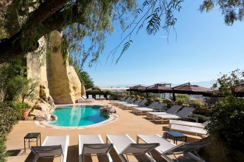 a pool with chaise lounge chairs and a resort at San Francesco al Monte in Naples