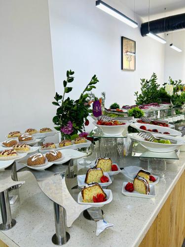 a buffet with many plates of food on a table at Karvan Sanatorium Naftalan in Naftalan