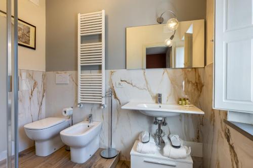 a bathroom with a sink and a toilet and a mirror at B&B Ninfeo dell' Arancera in Calci