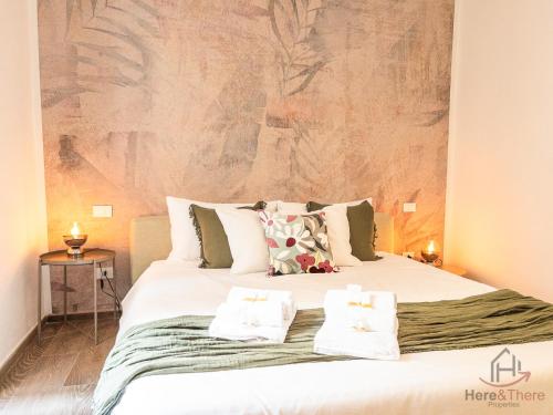 a bedroom with a large bed with two pillows on it at Prince Suite - Trains 4 min - AC - Super Wifi in Genova