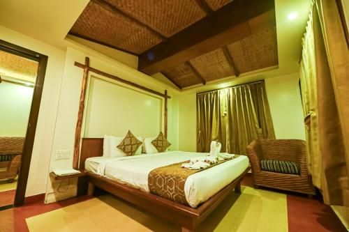 a hotel room with a bed and a window at Sepoy Grande Mysore in Mysore