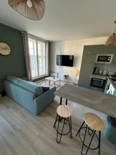 a living room with a blue couch and a table at The Best View 65 Grand place Superbe vue avec Jaccuzi in Arras