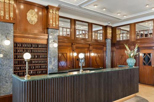 a wine tasting room with a bar in a building at Hotel Astoria Vienna, Curio Collection by Hilton in Vienna
