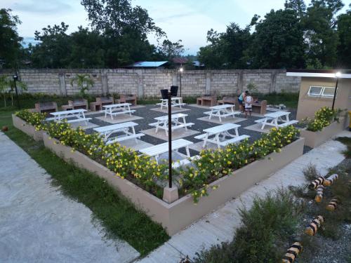 a parking lot with white tables and yellow flowers at Lai Stay in Lapu Lapu City
