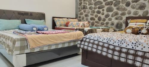 Postel nebo postele na pokoji v ubytování Harmony Resto&Homestay