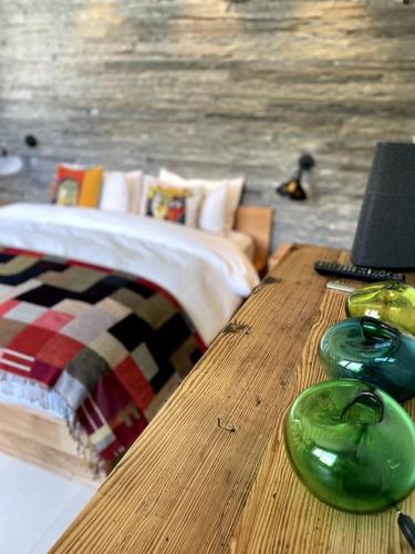 a bedroom with a bed and a wooden table at Private luxury 4 bedroom apartment in Flims Waldhaus in Flims