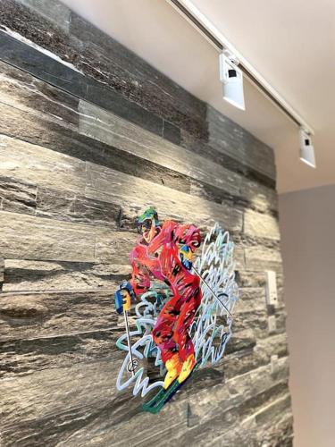 a painting of a skier on a wall at Private luxury 4 bedroom apartment in Flims Waldhaus in Flims