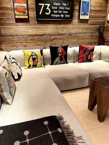 a living room with a couch with pillows on it at Private luxury 4 bedroom apartment in Flims Waldhaus in Flims