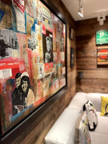 a living room with a couch and a painting on the wall at Private luxury 4 bedroom apartment in Flims Waldhaus in Flims