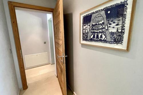 a picture hanging on a wall next to a door at Private luxury 4 bedroom apartment in Flims Waldhaus in Flims