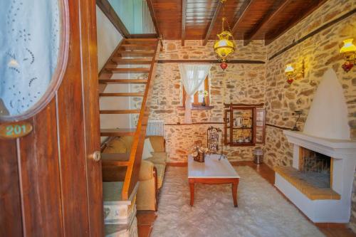 a living room with a staircase and a table at Palladio Hotel - Portaria in Portaria