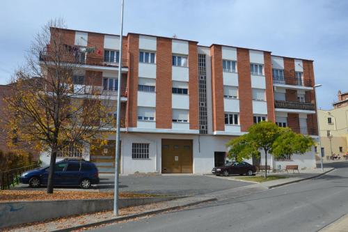 a large brick building with a car parked in front of it at Los Borgia in Viana