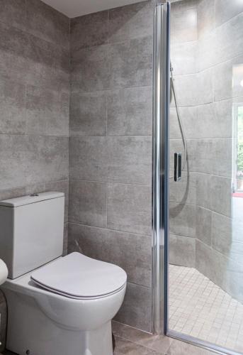 a bathroom with a toilet and a shower at No 1 Killarney Holiday Village Vacation Home in Killarney