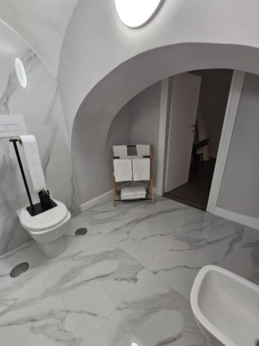 a bathroom with a toilet and a sink at Napoli the charme in Naples