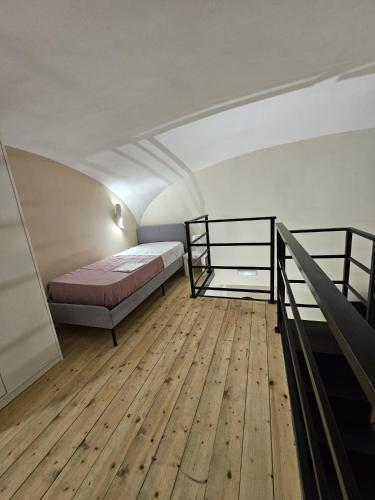 a bedroom with a bed and a wooden floor at Napoli the charme in Naples