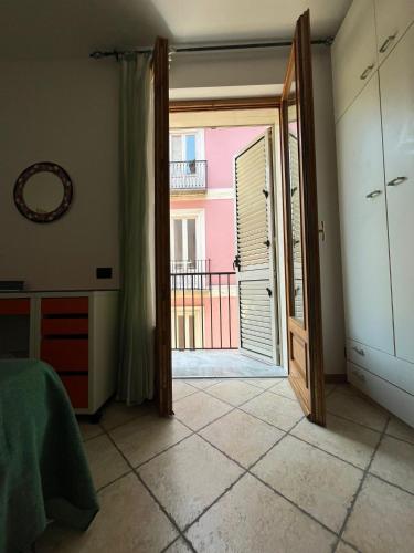 a bedroom with a door open to a balcony at Normanni 28 - Private and Guest House in Campagna