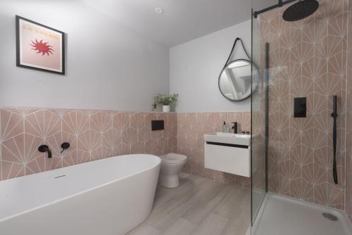 a bathroom with a tub and a toilet and a sink at The Elms in Uny Lelant