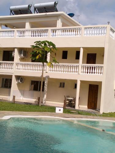 a large house with a swimming pool in front of it at SHIMBA SPRINGS MBUYU. ( Malindi) in Malindi