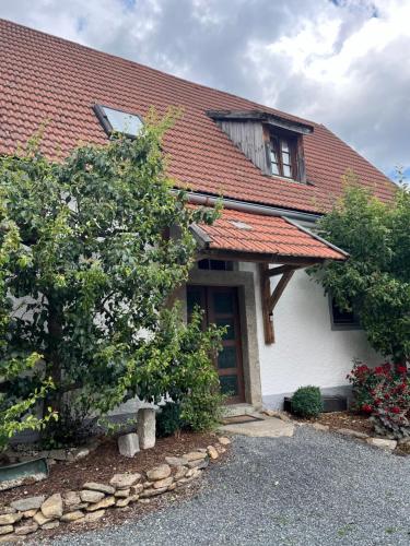 a white house with a red roof at Der Grandlhof - Ferien am Hof in Krummennaab