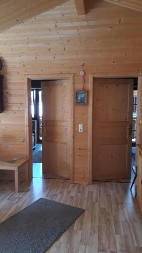 two doors in a room with wooden walls at Ferienhaus Rita in Kals am Großglockner