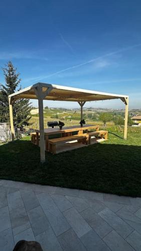 a gazebo with a picnic table in the grass at Il Sogno di Elisa Country House in Calosso