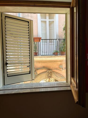 an open window with a view of a balcony at Normanni 28 - Private and Guest House in Campagna