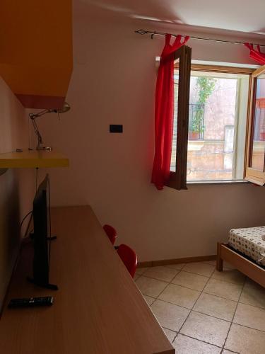 a living room with a table and a window at Normanni 28 - Private and Guest House in Campagna