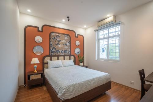 a bedroom with a bed and a window at Spacious Hoan Kiem Apartment in Hanoi