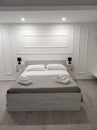 a bedroom with a large bed with two towels on it at Residenza Atena Tropea in Tropea