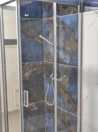 a shower with a glass door in a bathroom at Residenza Atena Tropea in Tropea