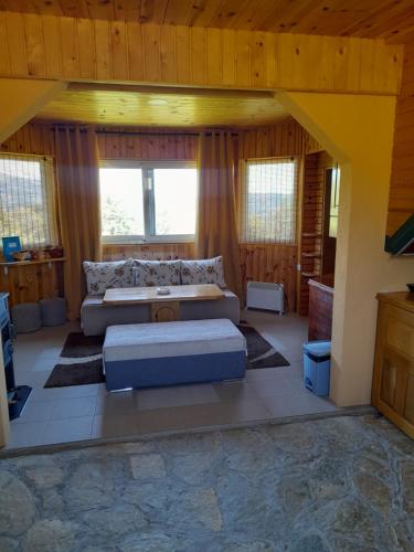 a living room with a couch and a table at Ethno village & resort Ćorić in Mojkovac