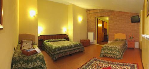 En eller flere senge i et værelse på LH Albergo Il Picchio